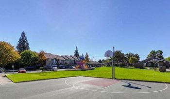 a basketball court in the middle of a neighborhood